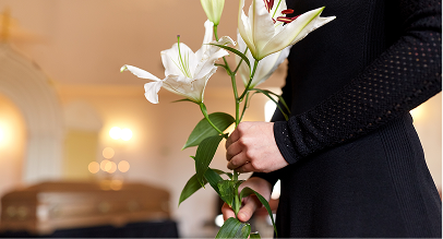 a funeral director holding flowers
