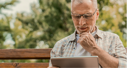 a man looking at an iPad