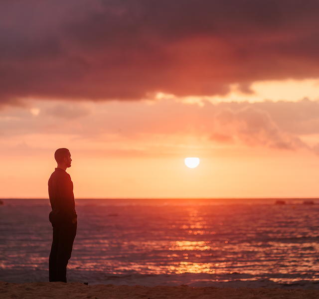 a man looking at the sunset