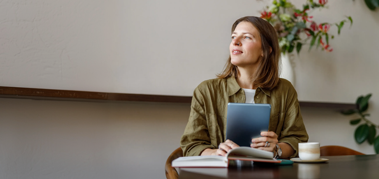 woman looking up from her iPad