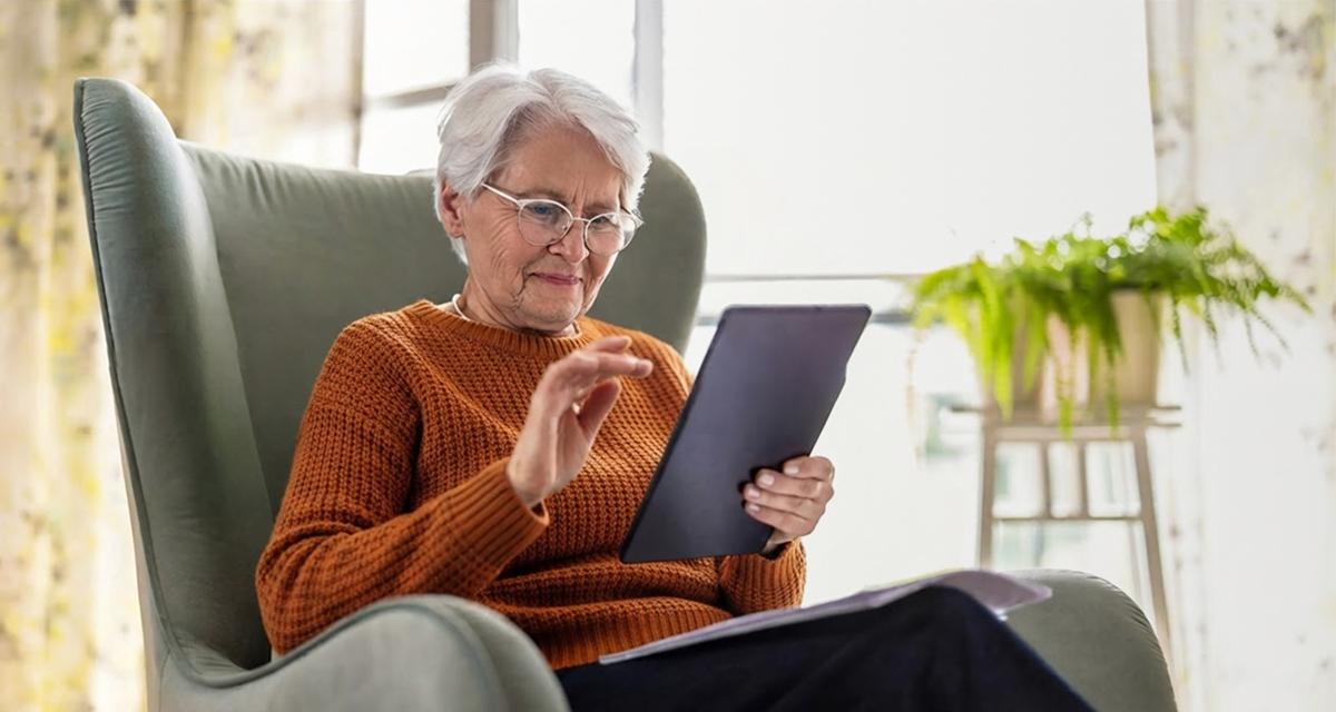 an elderly woman looking at an iPad