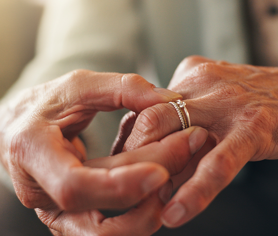 a woman putting a ring on