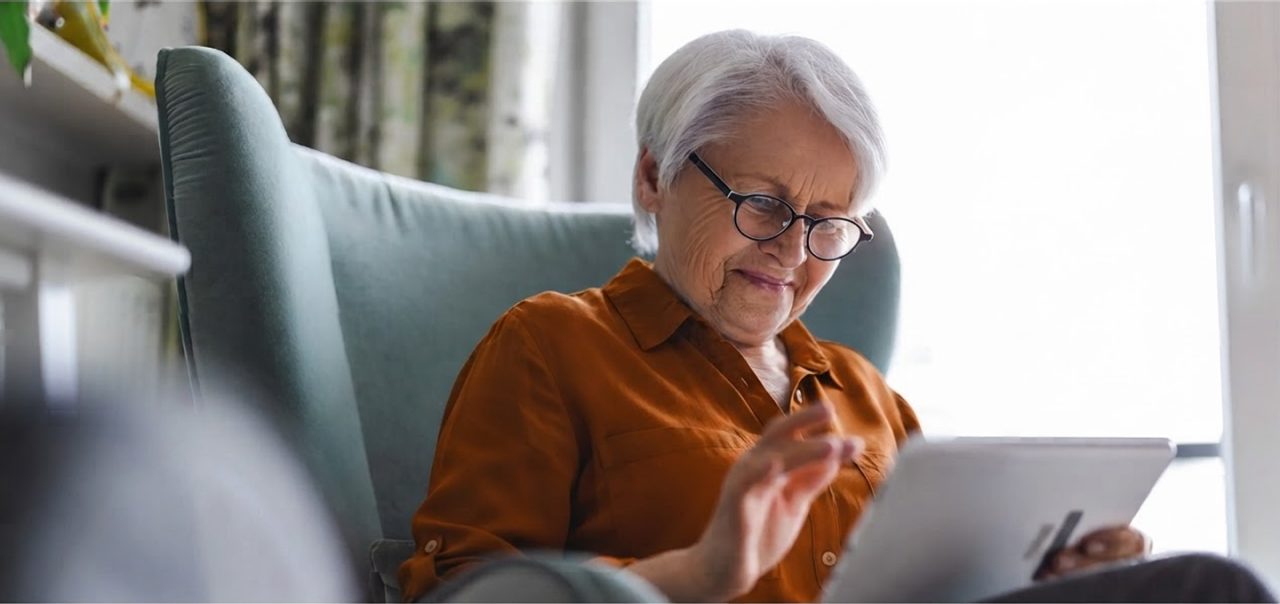 an elderly woman looking at iPad