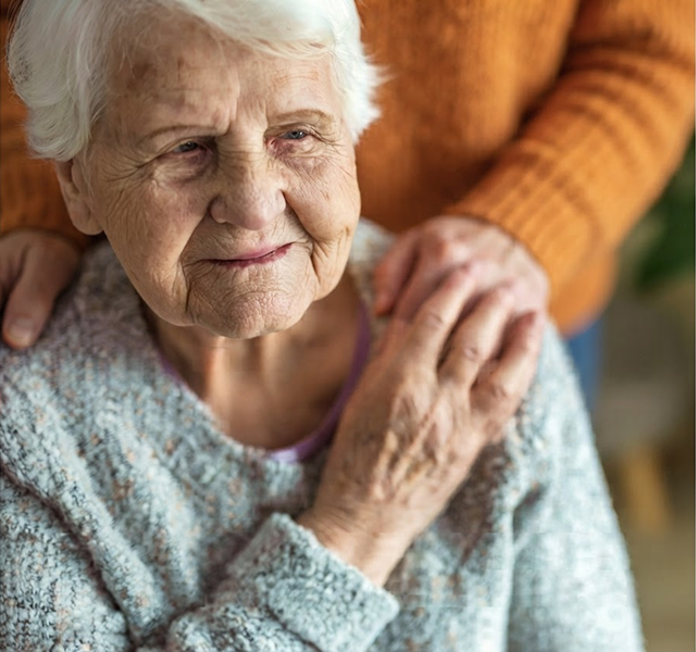 an elderly woman getting comfort from her grandaughter