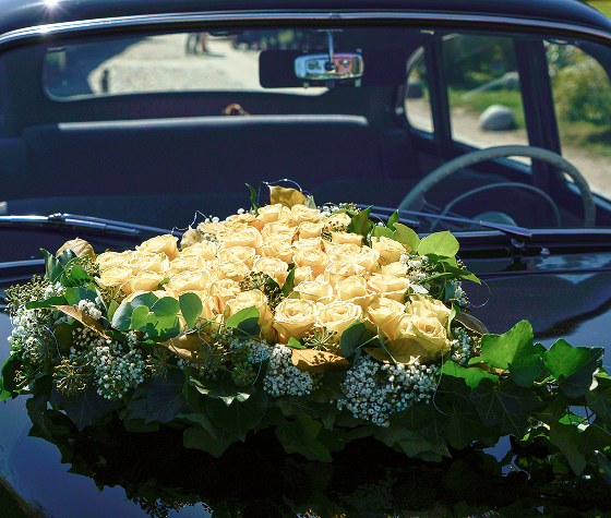 floral arrangement on top of hearse