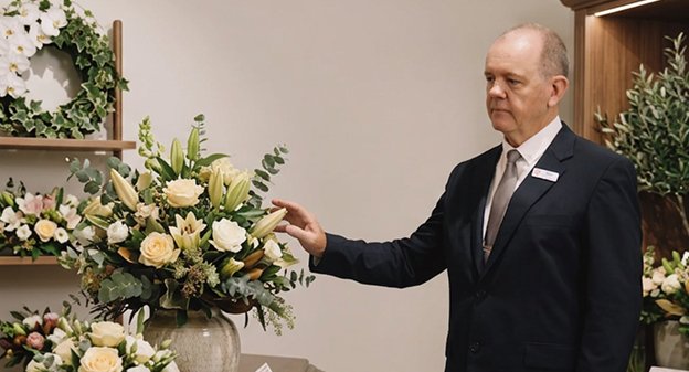 City funeral director with flower arrangement